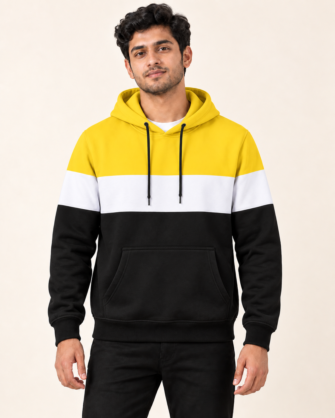 Model wearing a plain yellow, white and black colourblock fleece pullover hoodie