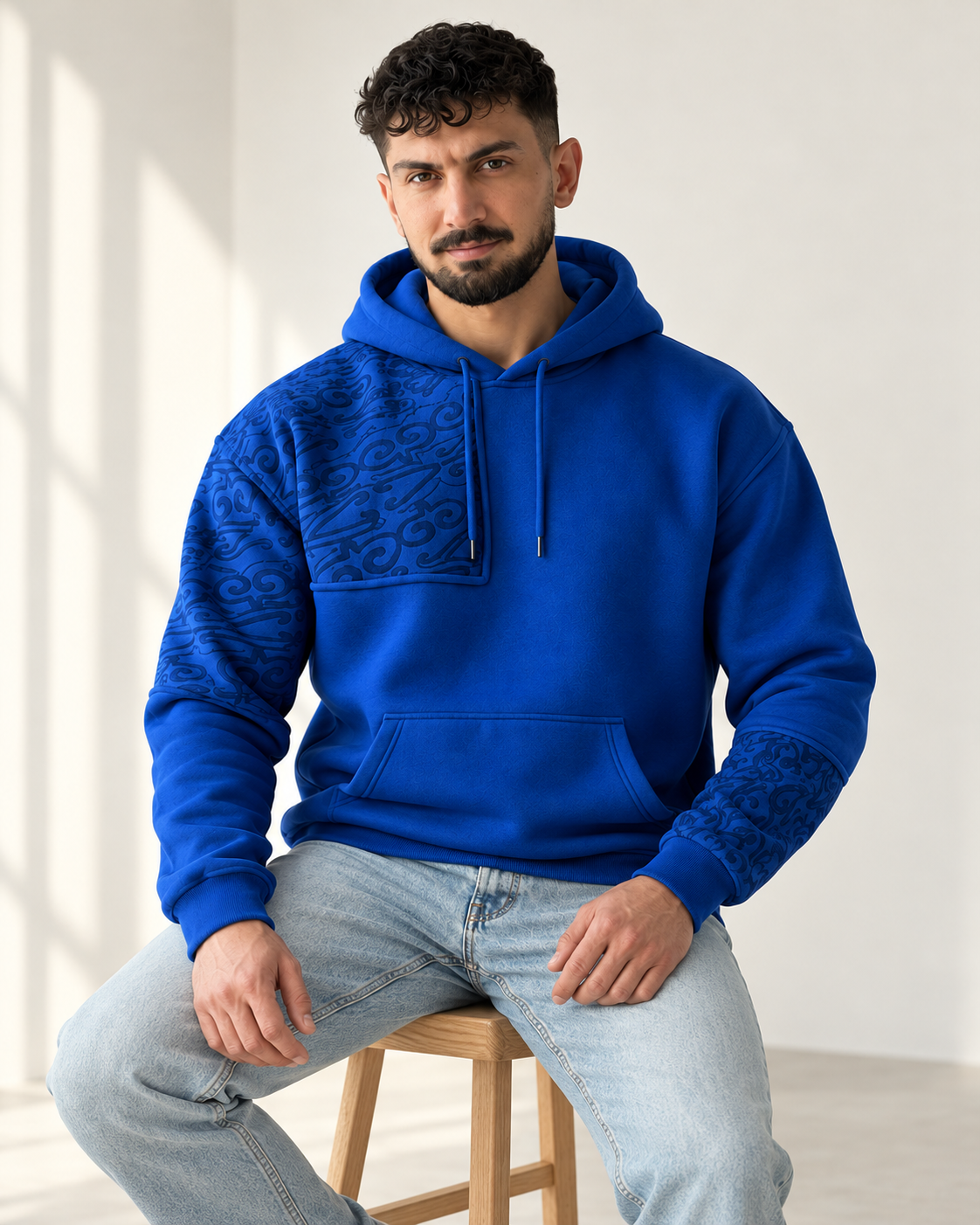 Royal Blue Ornamental Print Fleece Hoodie for men — seated lifestyle view
